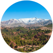 Panoramic view of the Atlas Mountains during the ideal season for visitors, showcasing the vibrant colors and serene landscapes.